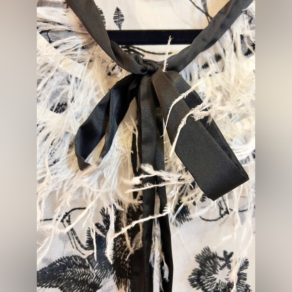 White sheer black floral top with black satin bow ribbon at neck w/ feathers. - Picture 3 of 5